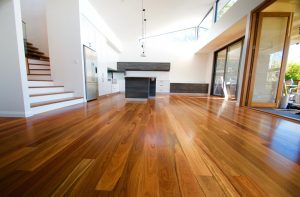 shows a new timber floor and large open kitchen and living space
